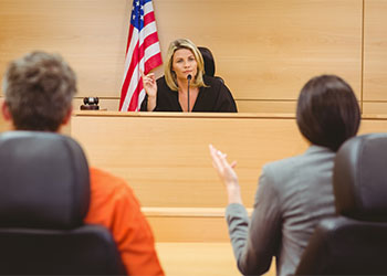 Judge and lawyer discussing the sentence for prisoner
