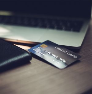 Credit Card and Wallet by a laptop, credit card in focus
